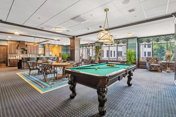 Bright interior common area with a pool table