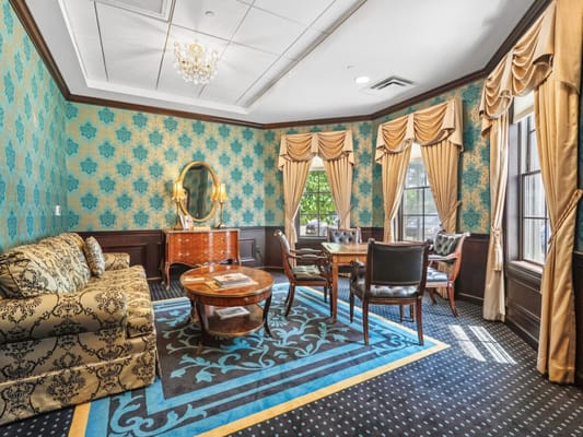 Elegant common area with blue wallpaper and seating