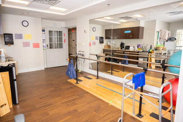 Rehabilitation room with exercise equipment and mirrors