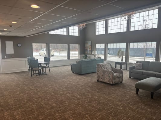 Bright common area with large windows and comfortable seating