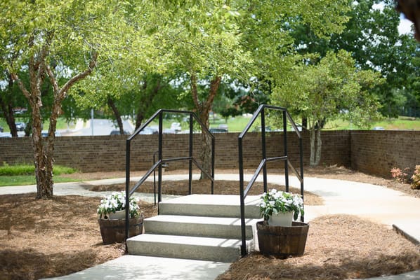 Outdoor pathway with stairs and flowerpots