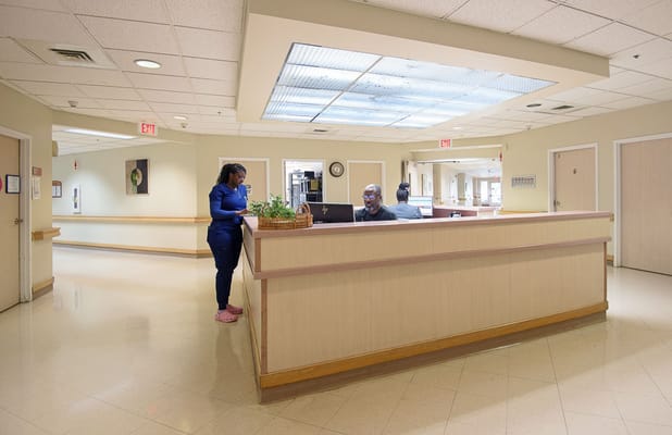 Reception area with staff assisting visitors