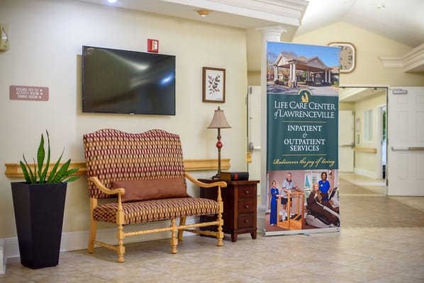 Interior view of a common area with seating and signage