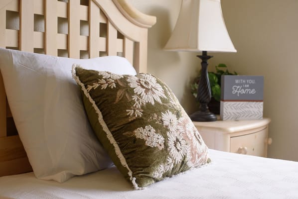Decorative pillow and lamp in a cozy bedroom