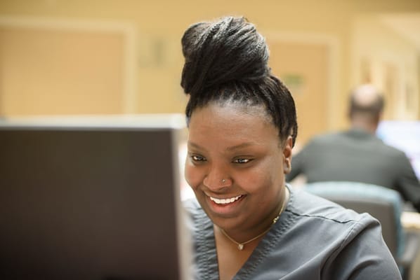 Staff member working on a computer in the facility