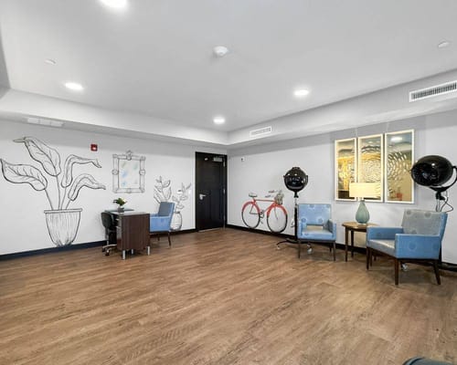 Common area with seating and decor in a senior facility