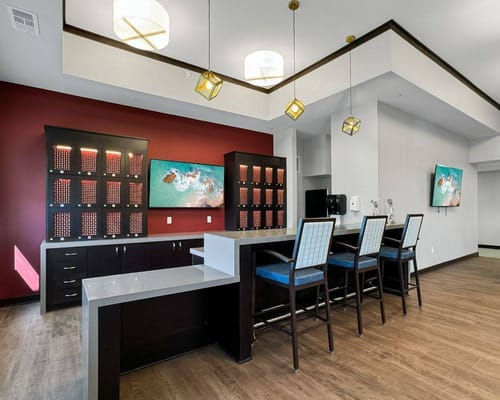 Bright common area with seating and TV screens