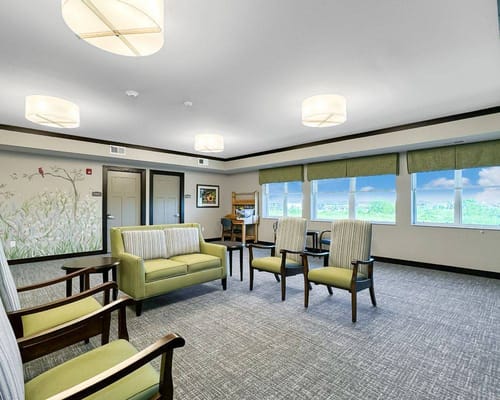 Bright common area with green and beige furnishings