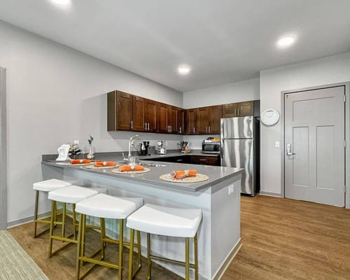 Modern kitchen space with bar seating and appliances