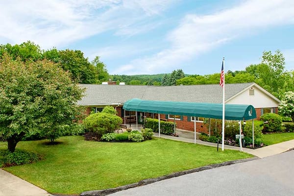 Exterior view of a senior living facility with green awning
