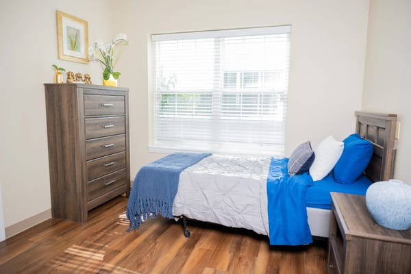 Well-furnished resident room with natural light