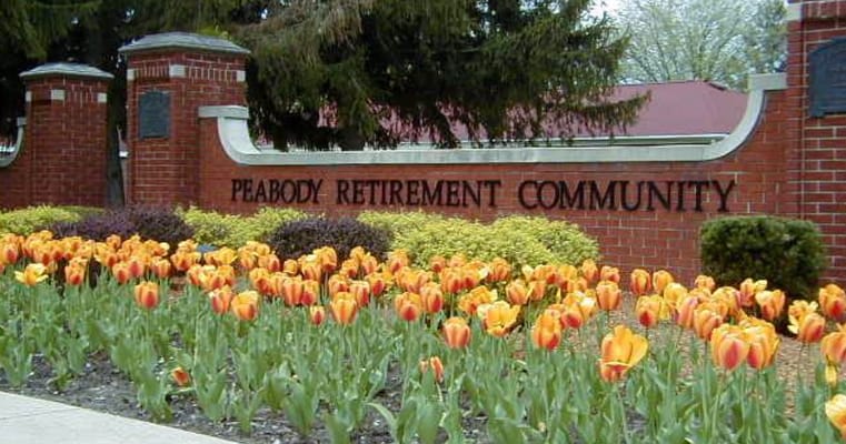 Exterior view of Peabody Retirement Community with blooming flowers