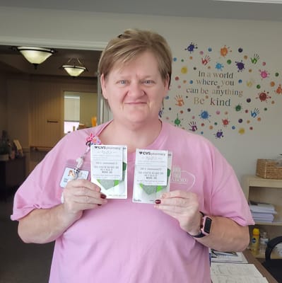 Staff member holding pharmacy items in a common area
