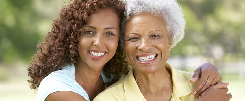 Two women smiling together outdoors