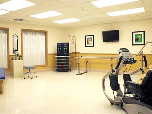 A well-equipped therapy room with exercise machines
