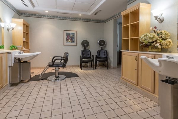 Interior of a hair salon with styling chairs and hair dryers