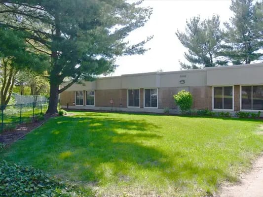 Outdoor area with lawn and trees near the facility