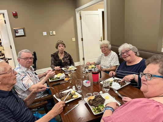 Residents enjoying a meal together in the dining room