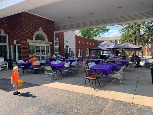 Outdoor event setup with tables and a child