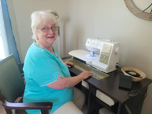 Resident sewing in a cozy interior