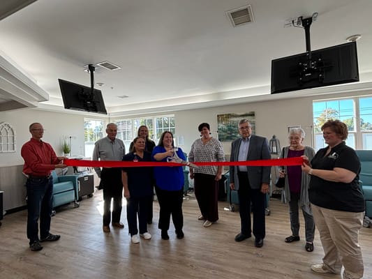 Ribbon-cutting ceremony with staff and community members