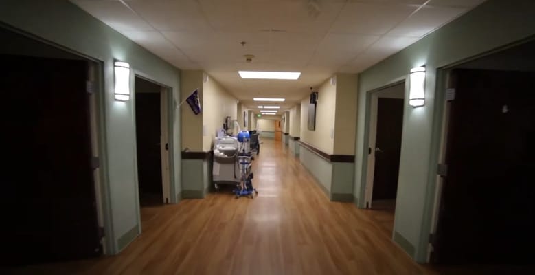 A hallway in a nursing home facility with medical equipment