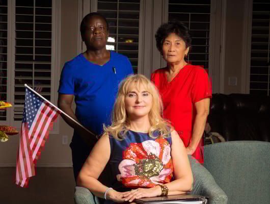 Staff members and a resident posing together indoors