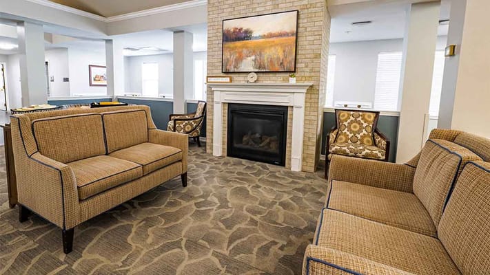 Comfortable common area with couches and a fireplace