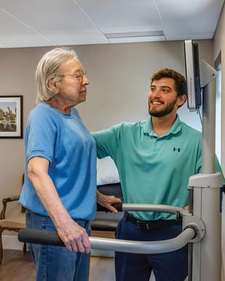 Therapist assisting resident during physical therapy session