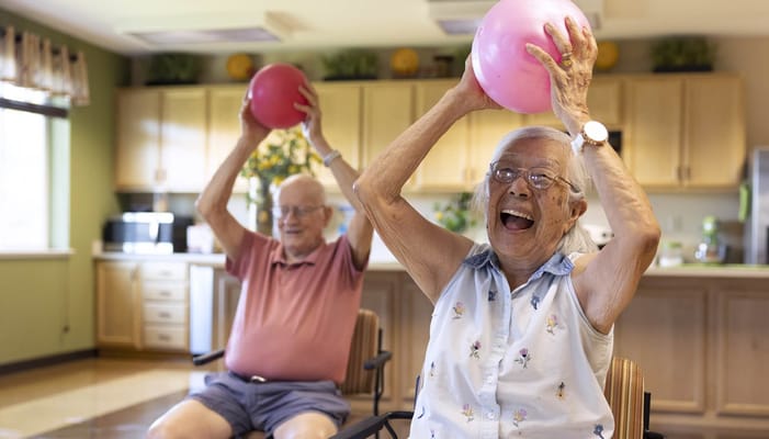 Residents participating in a fun exercise class with balls