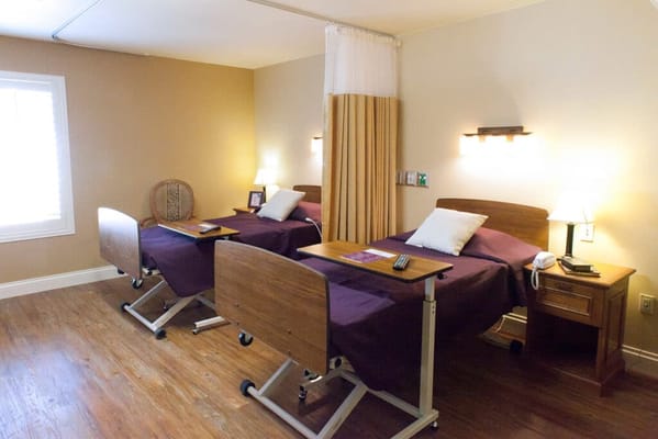 Shared resident room with two beds and personal items