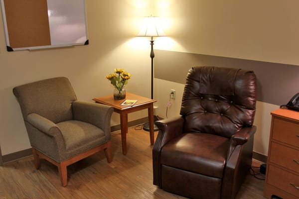 Comfortable seating area with a lamp and flowers