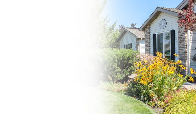 Exterior view of Ashley Manor surrounded by flowers