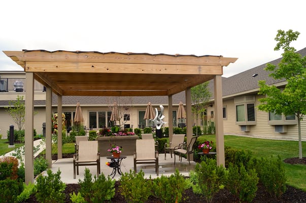 Outdoor seating area with flowers and patio cover