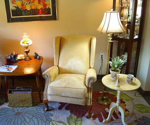 Cozy corner of a common area with a chair and lamp