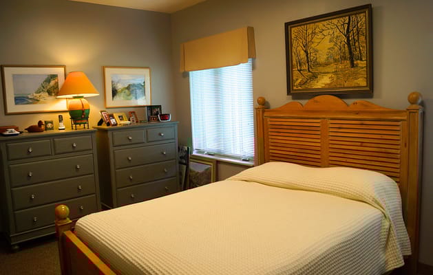 Cozy resident room with a bed and dresser