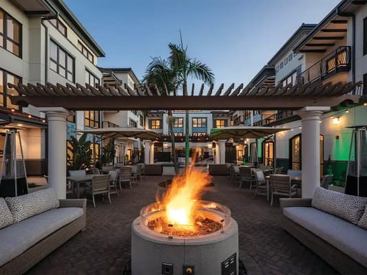 Outdoor patio area with a fire pit and seating