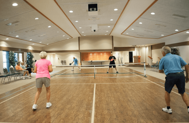 Residents playing pickleball in a common area