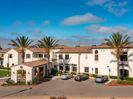 Exterior view of Westmont Village Homes with palm trees
