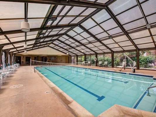 Indoor swimming pool area with seating
