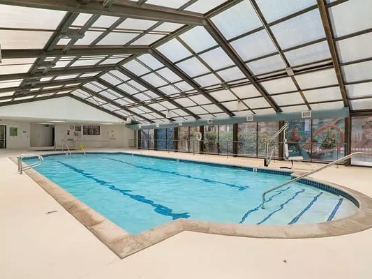 Indoor swimming pool area with a sunroof