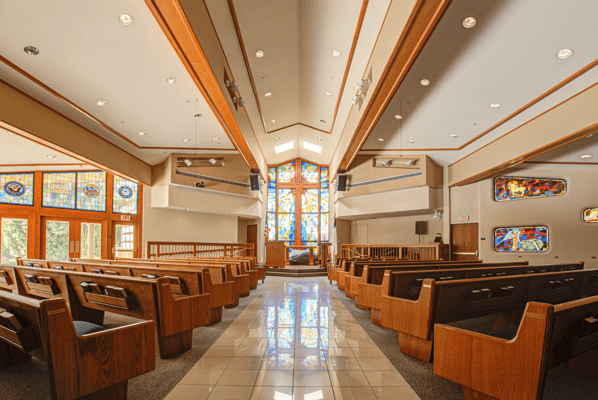 Interior view of a chapel with stained glass windows