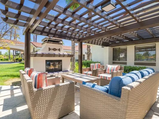 Outdoor social area with seating and fireplace