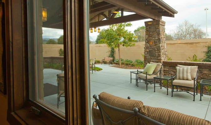 Outdoor patio area with stone accents and seating