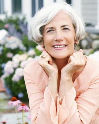 Smiling older woman in a garden setting