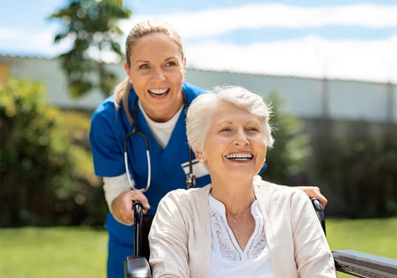 Caregiver assisting a resident in a garden