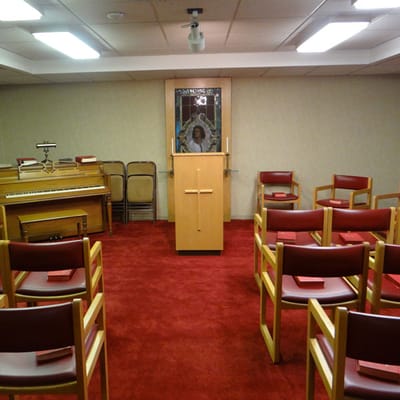 Interior of a quiet chapel space with chairs and altar
