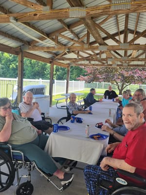 Residents enjoying a meal outdoors at a gathering