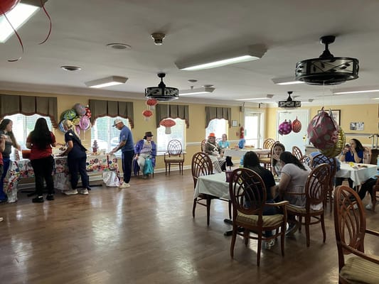 Residents and staff celebrating in a bright common area