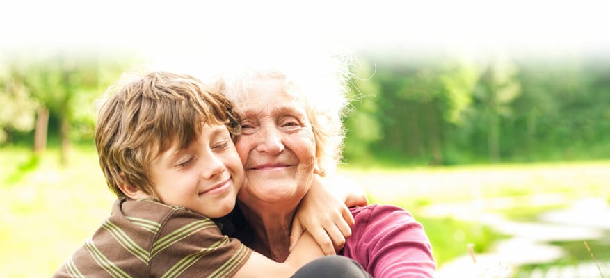 Grandmother and grandson sharing a joyful moment outdoors